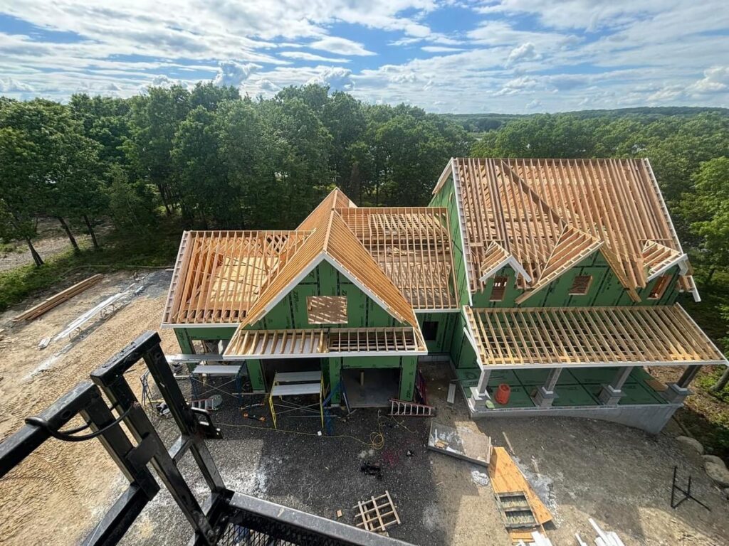 Drone aerial view of luxury custom home framing and roof construction