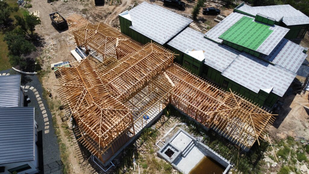 Luxury custom home construction project with completed framing viewed from above in Austin Texas