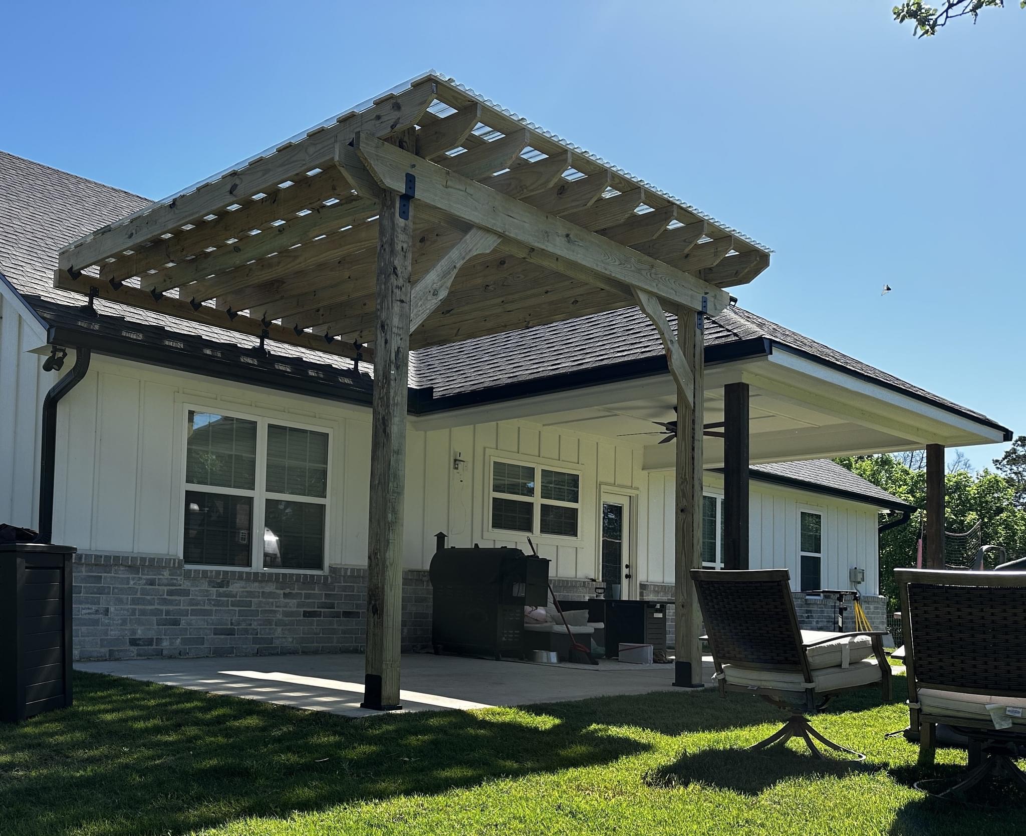 Freestanding pergola with weather-resistant roofing panels for backyard outdoor living area in Austin, TX