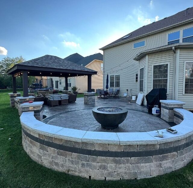Outdoor living space featuring pavilion cover, seating area, and fire feature.