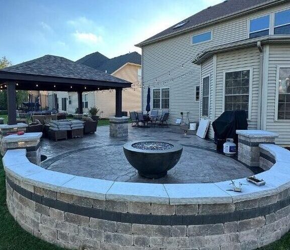Outdoor living space featuring pavilion cover, seating area, and fire feature.